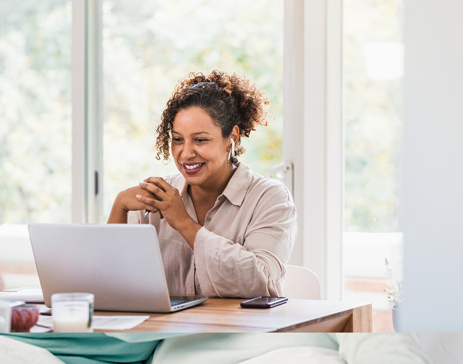 Stock image of adult woman sitting at a laptop