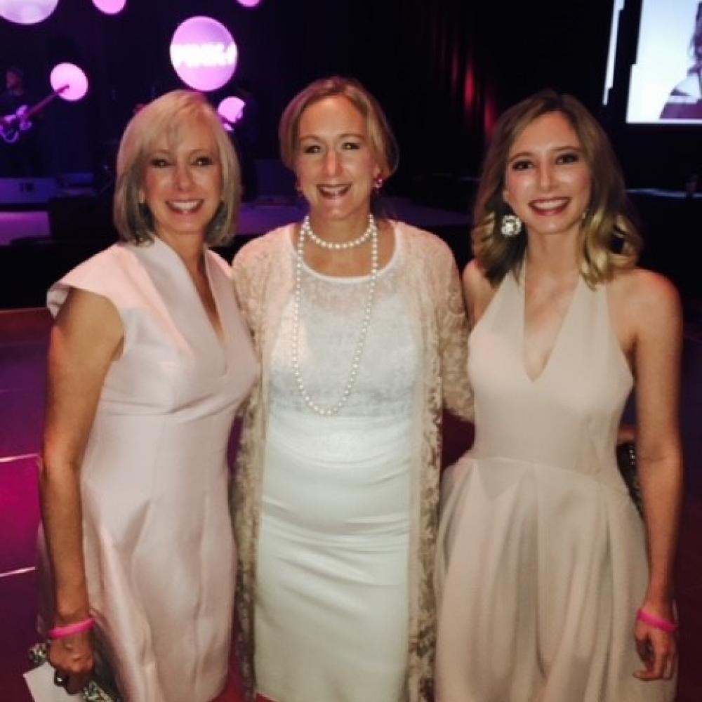 From left to right: Molly Sherman, Dr. Debra Patt, Hattie Sherman. All three women are at a formal event and are wearing white and/or light-pink dresses, smiling facing forward.