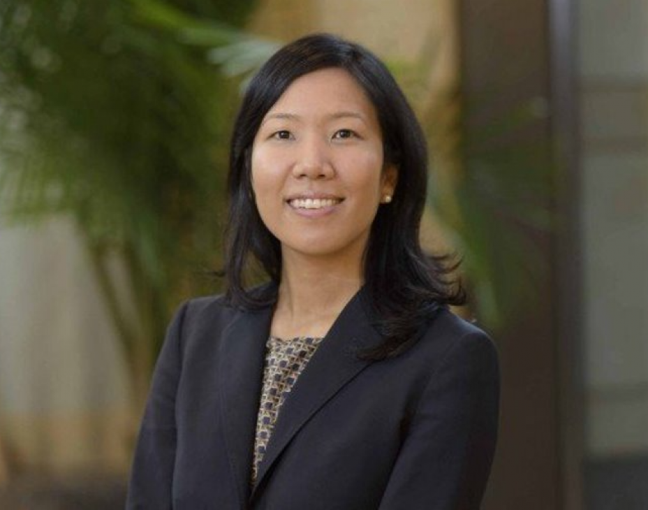 Headshot of Dr. Chrisann Kyi. She is smiling facing forward and wearing a black blazer and has shoulder-length black hair.