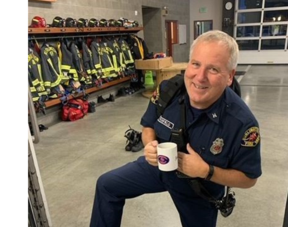 Jerry in a firefighter uniform in a fire station setting