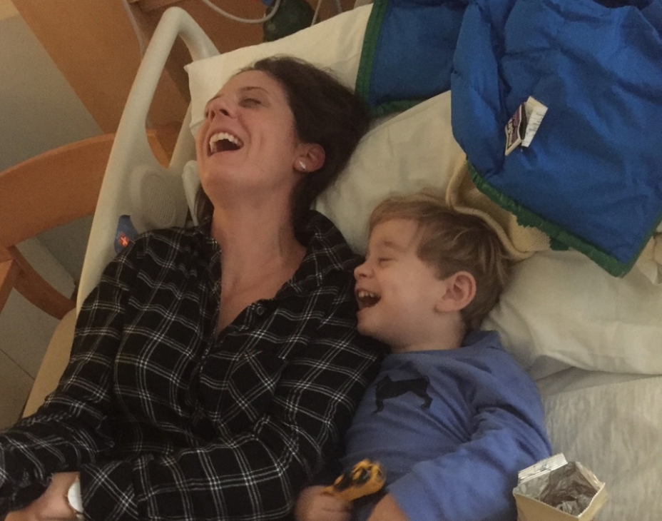 Caitlin and Calum laughing together in a hospital bed