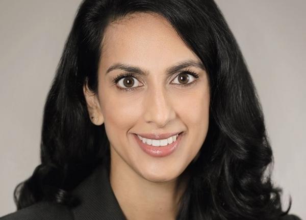 Dr. Lekha Mikkilineni smiling facing forward. She is wearing a black blazer and has long black hair.