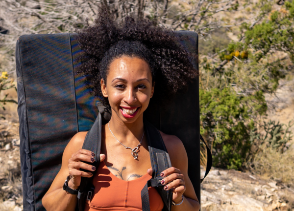 Favia Dubyk on a hike with hiking gear, outdoors, smiling facing forward.