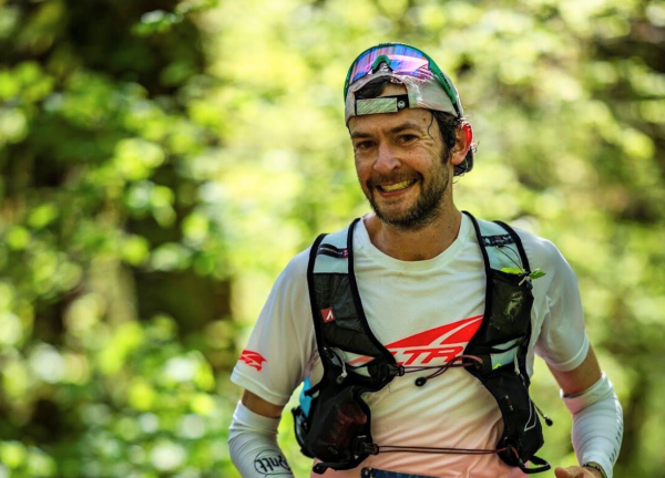 Dr. Justin Grunewald running a distance race in athletic gear.