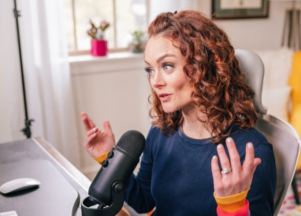 Kristin Flanary speaking into a microphone at her desk.