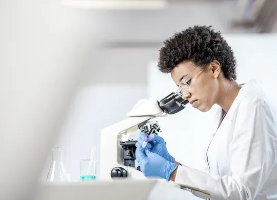 Scientist looking at vial of blood