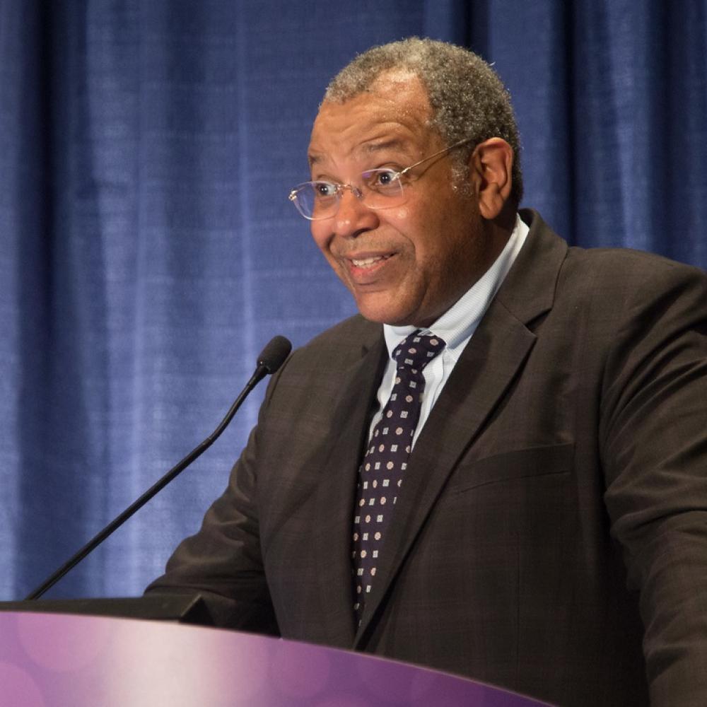 Dr. Otis Brawley speaking on a panel at an ASCO meeting.